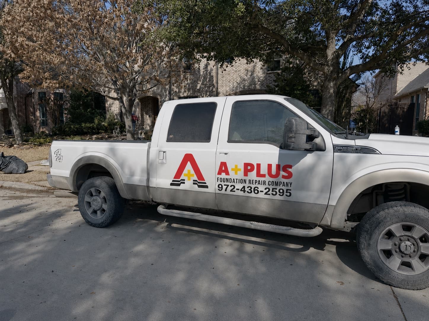 A+ Foundation Repair company truck parked at a residential job site in the Dallas/Fort Worth metroplex